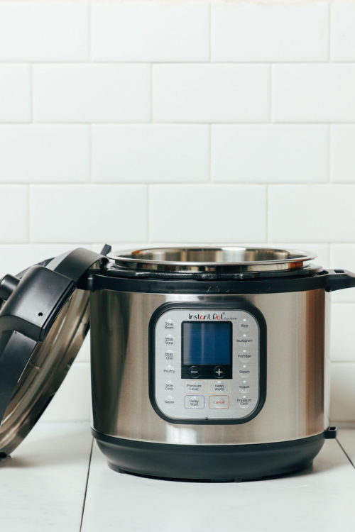 Open Instant Pot with lid resting against the base