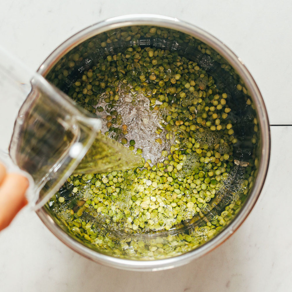 Pouring water into an Instant Pot of green split peas