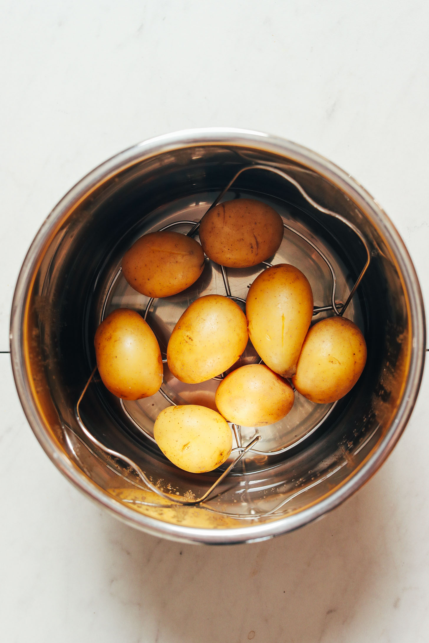 Gold potatoes on a trivet in the Instant Pot