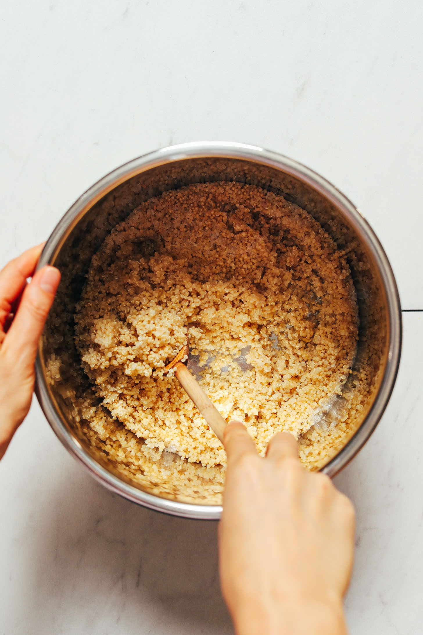 Stirring cooked quinoa in an Instant Pot