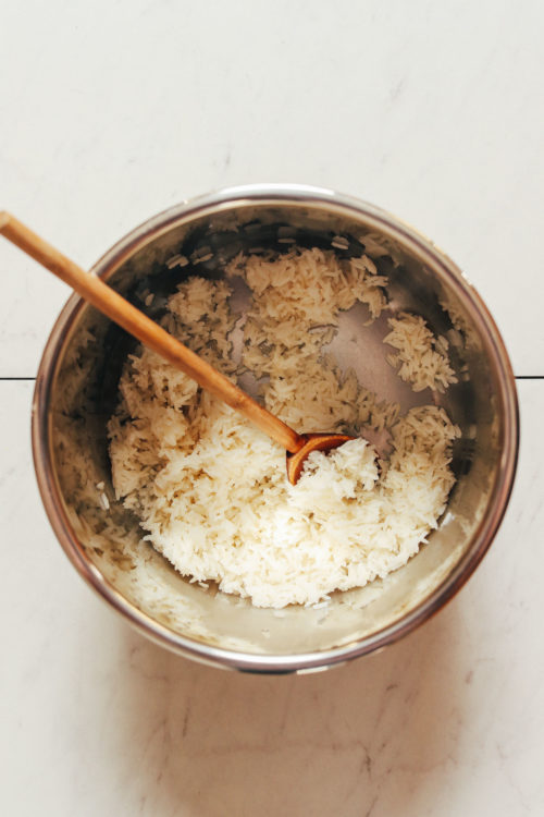 Wooden spoon in an Instant Pot of cooked white rice