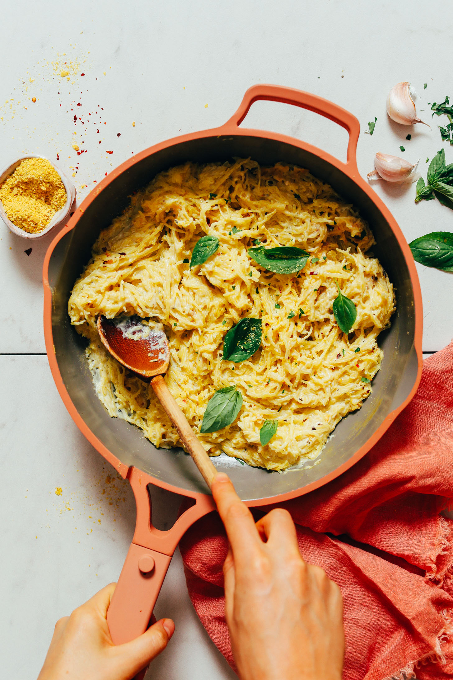 Pan of spaghetti squash pasta with fresh basil and vegan alfredo sauce