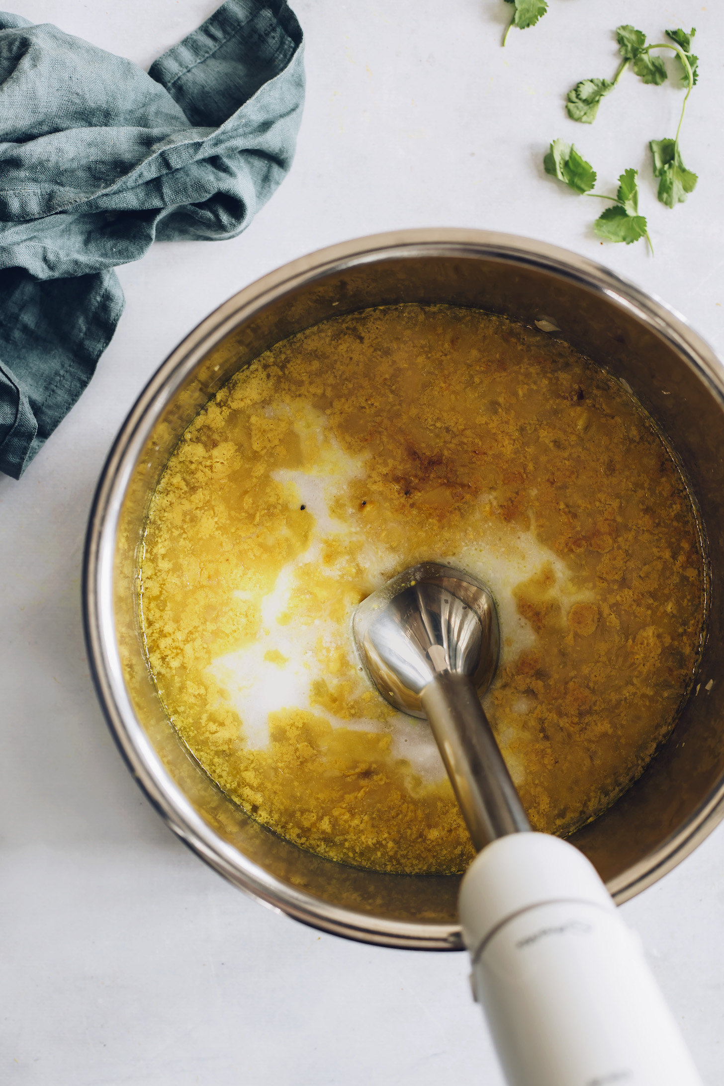 Using an immersion blender to purée split pea soup