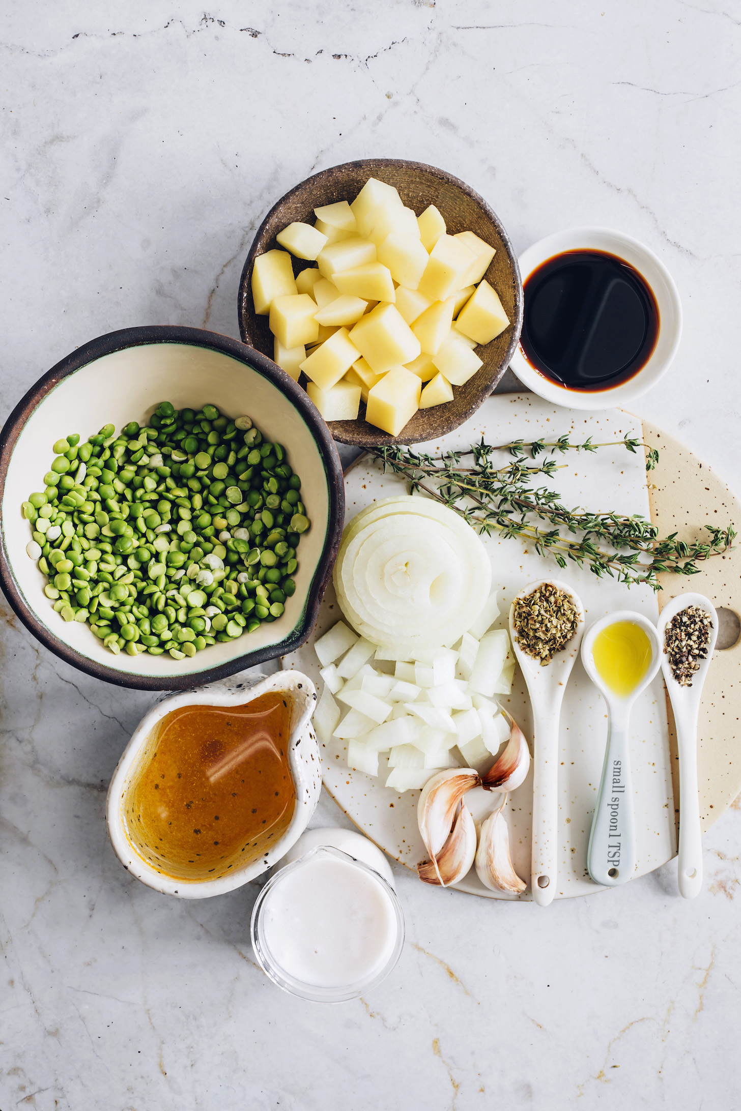 Potatoes, green split peas, onion, thyme, coconut aminos, garlic, oregano, pepper, olive oil, vegetable broth, and coconut milk
