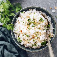 Cilantro next to a bowl of easy coconut rice