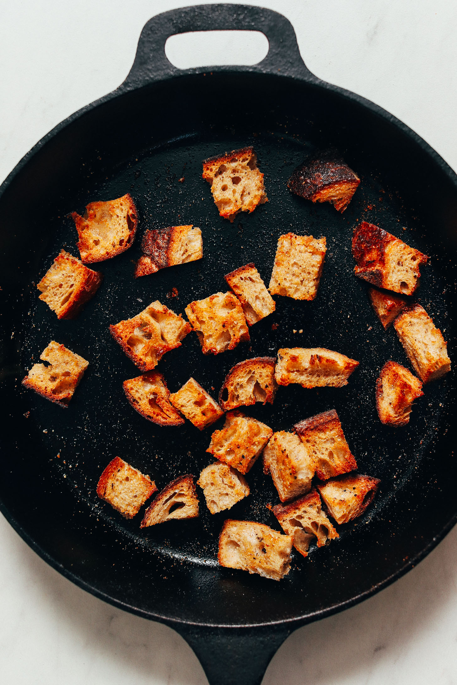 Homemade croutons in a cast iron skillet
