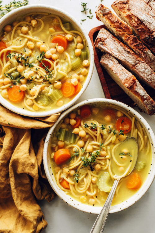 Bowls of vegan chicken noodle soup made with chickpeas
