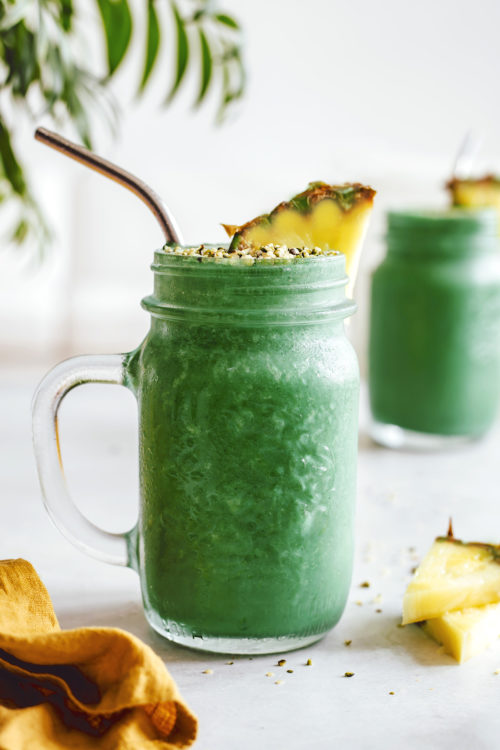 Refreshing green lemonade smoothies with pineapple and hemp seeds as garnish