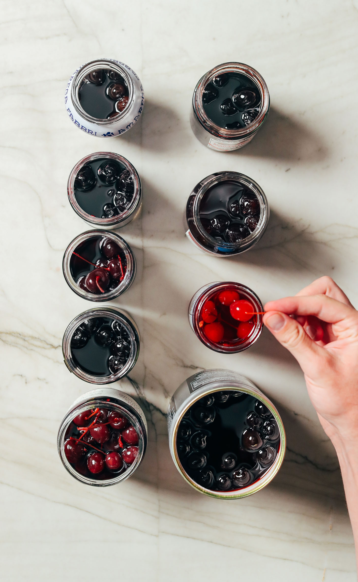 Assortment of cocktail cherries including in heavy and light syrup