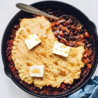 Vintage spoon in a pan of Cornbread and Black Bean Enchilada Skillet