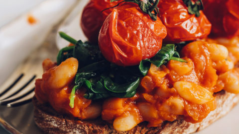 Roasted tomatoes, spinach, and baked beans on toast