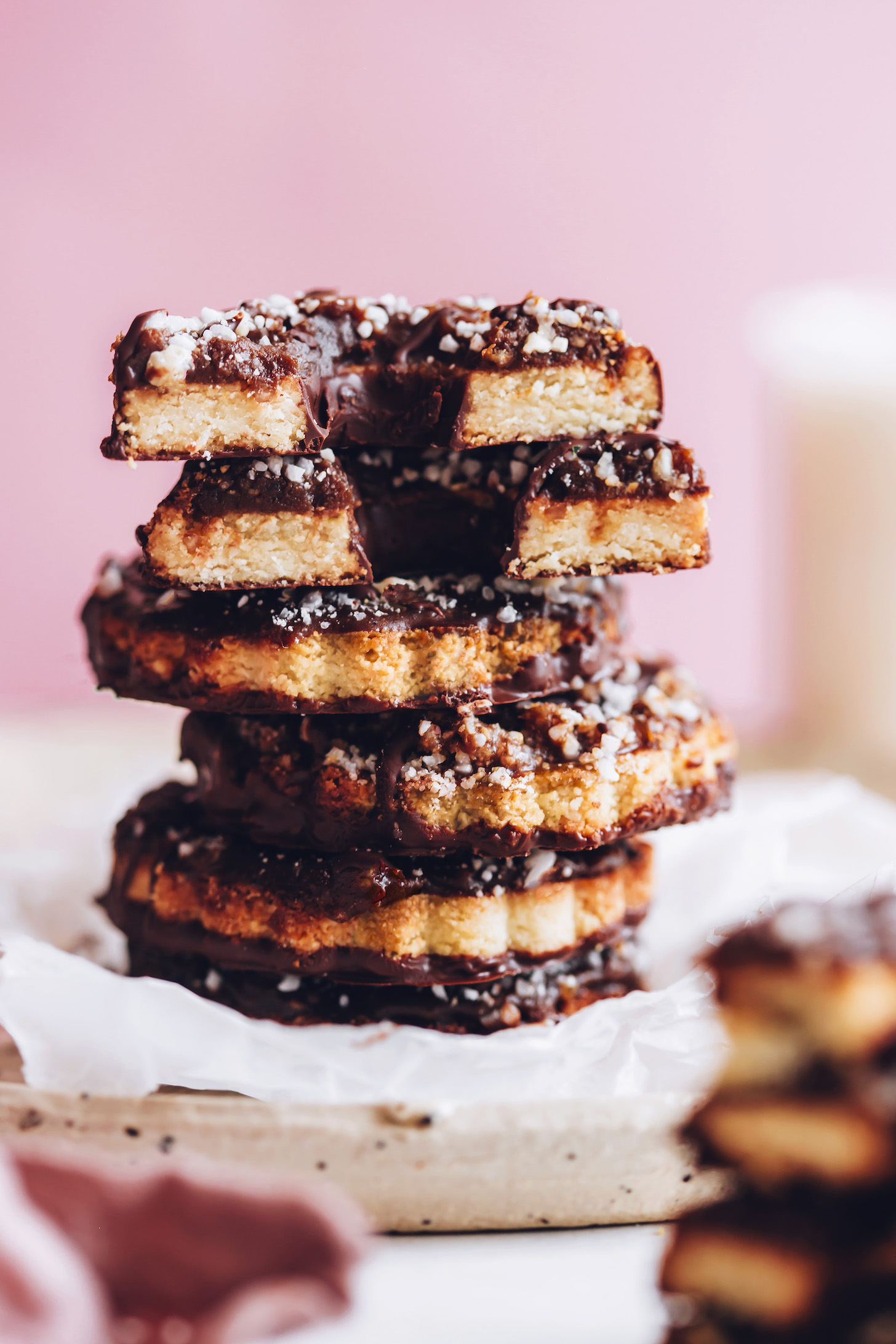 Stack of vegan gluten-free samoa cookies made with caramel, chocolate, and shredded coconut