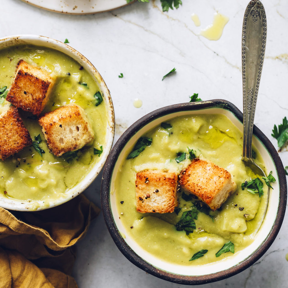 Bowls of Creamy Potato Green Split Pea Soup topped with croutons