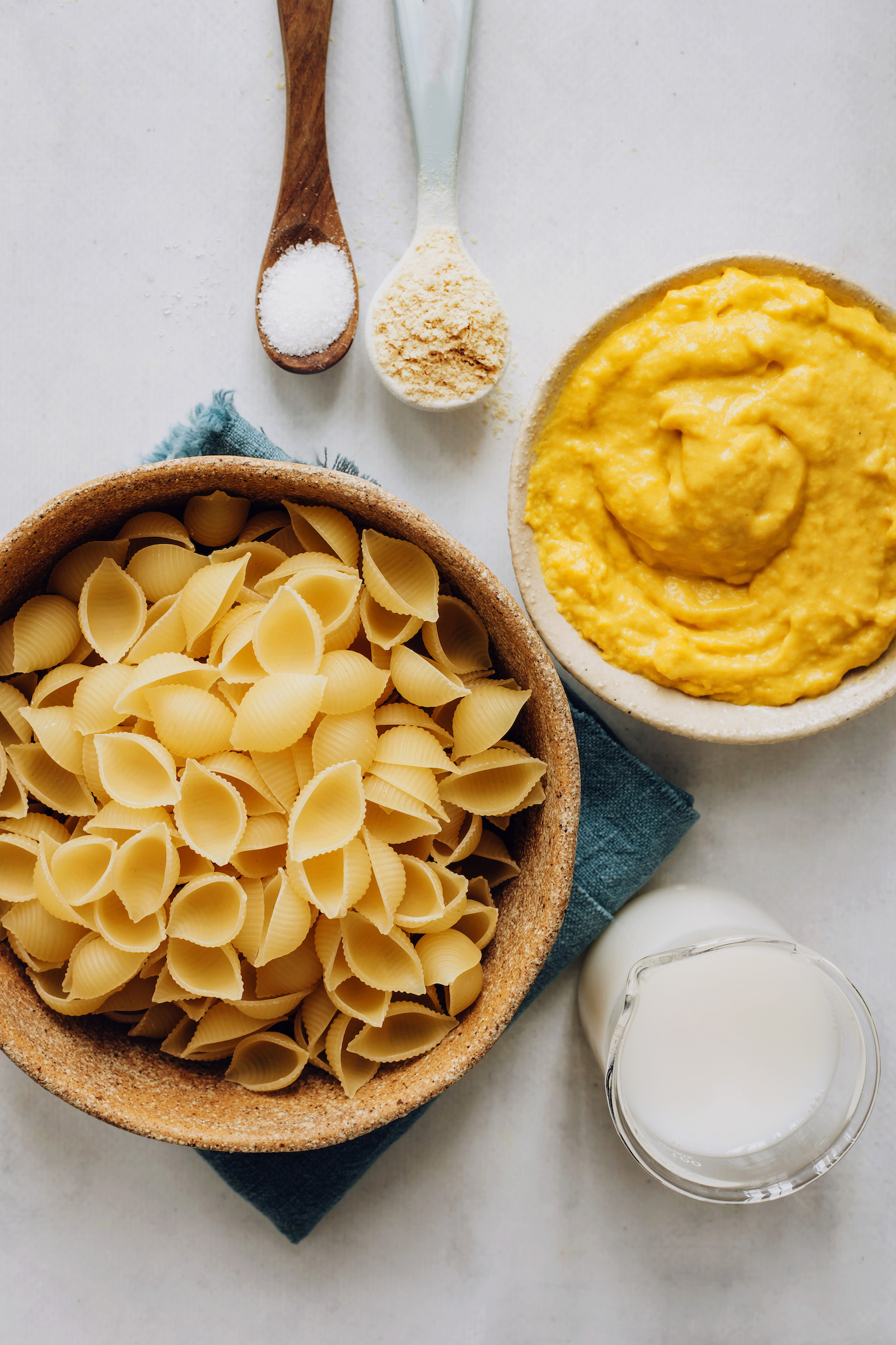 Chickpea pasta shells, salt, nutritional yeast, vegan cheddar cheese, and almond milk