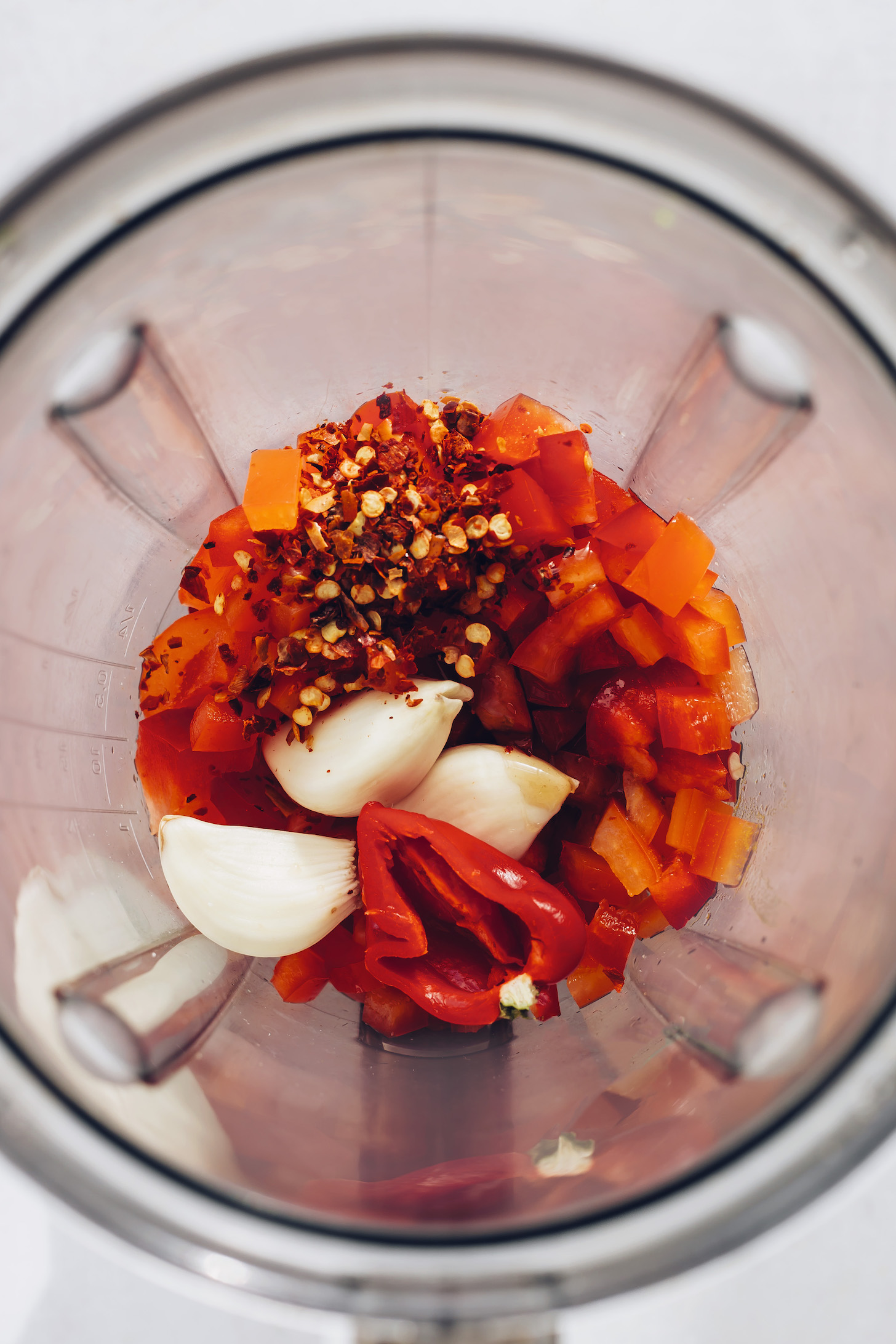 Blender with ingredients for making our easy homemade sriracha recipe