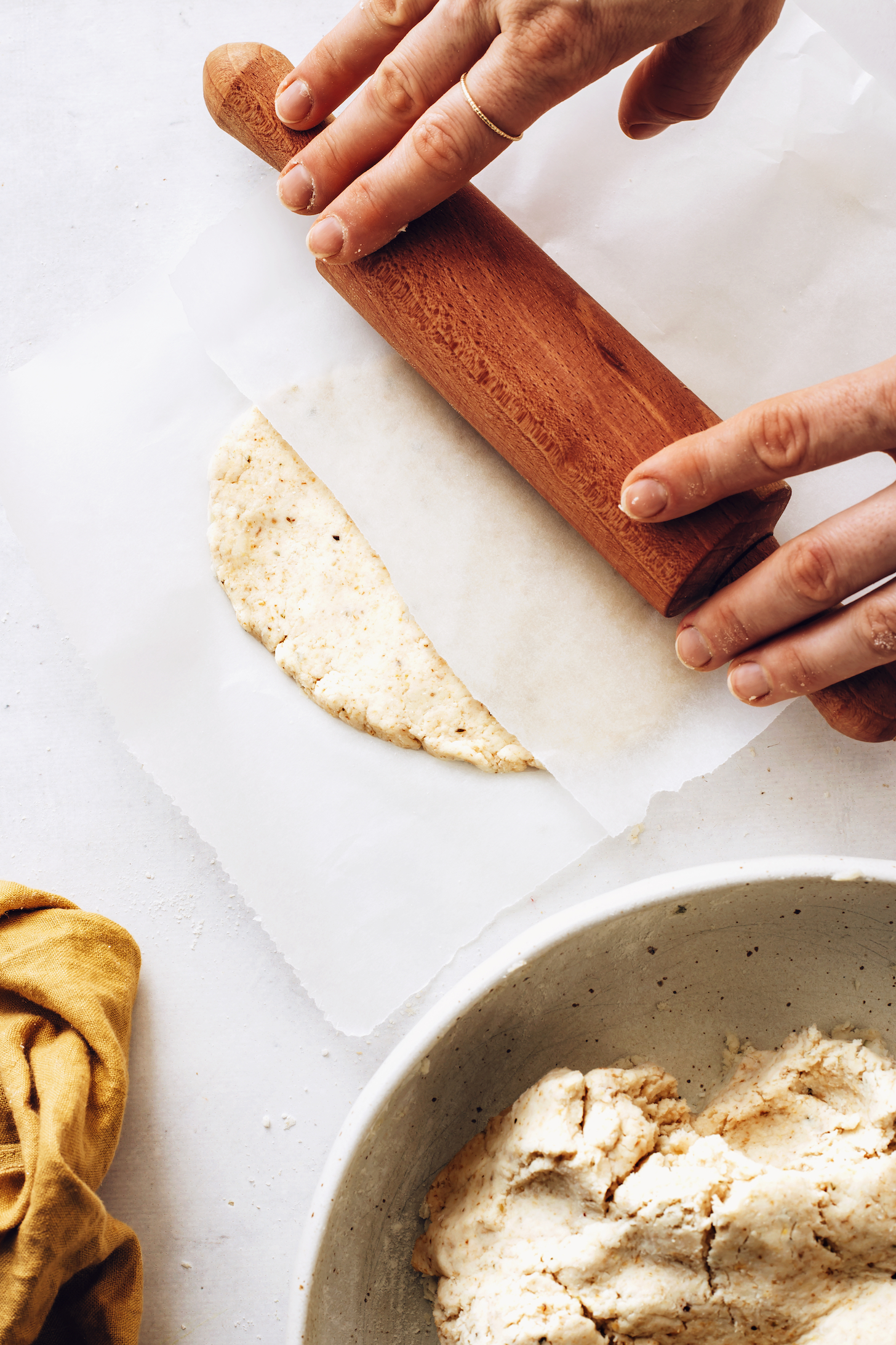 Using a rolling pin to roll out gluten-free flatbread