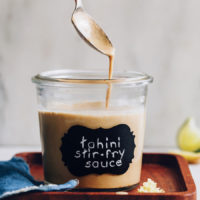 Easy tahini stir fry sauce on a spoon and in a jar