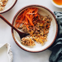 Bowl of carrot cake baked oatmeal topped with shredded carrots