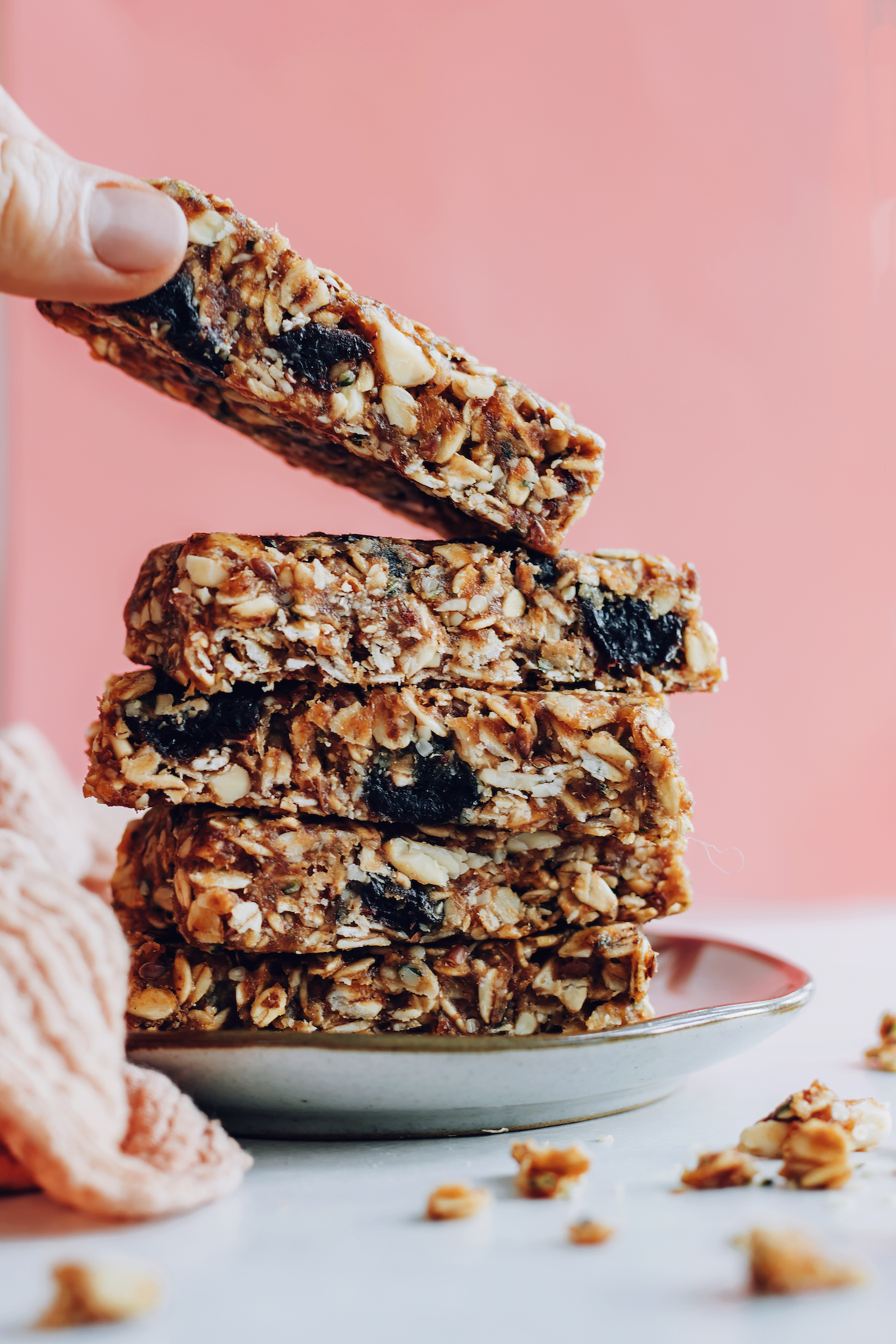 Picking up a healthy homemade granola bar from a plate