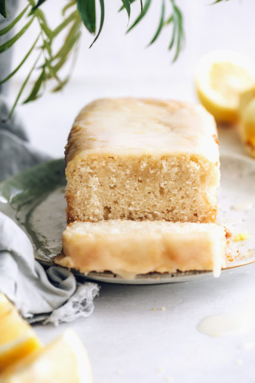 Partially sliced loaf of lemon cake