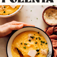 Hands holding the sides of a bowl of our Easy Vegan Polenta that's super creamy