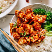 Bowl of General Tso Cauliflower with steamed broccoli and rice