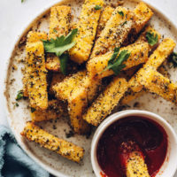 Plate of vegan parmesan and herb polenta fries