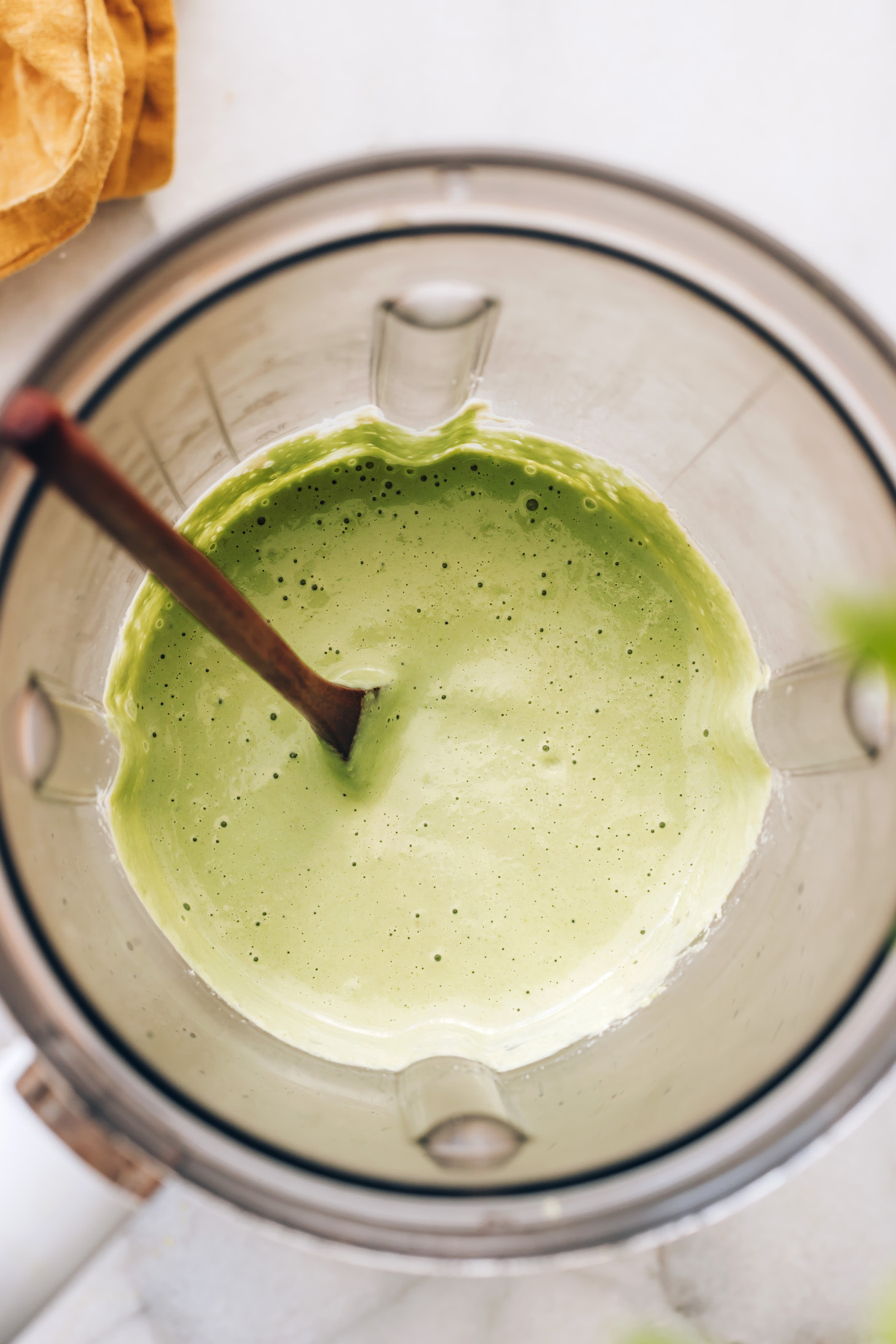 Top down view of a blender of creamy cilantro dressing