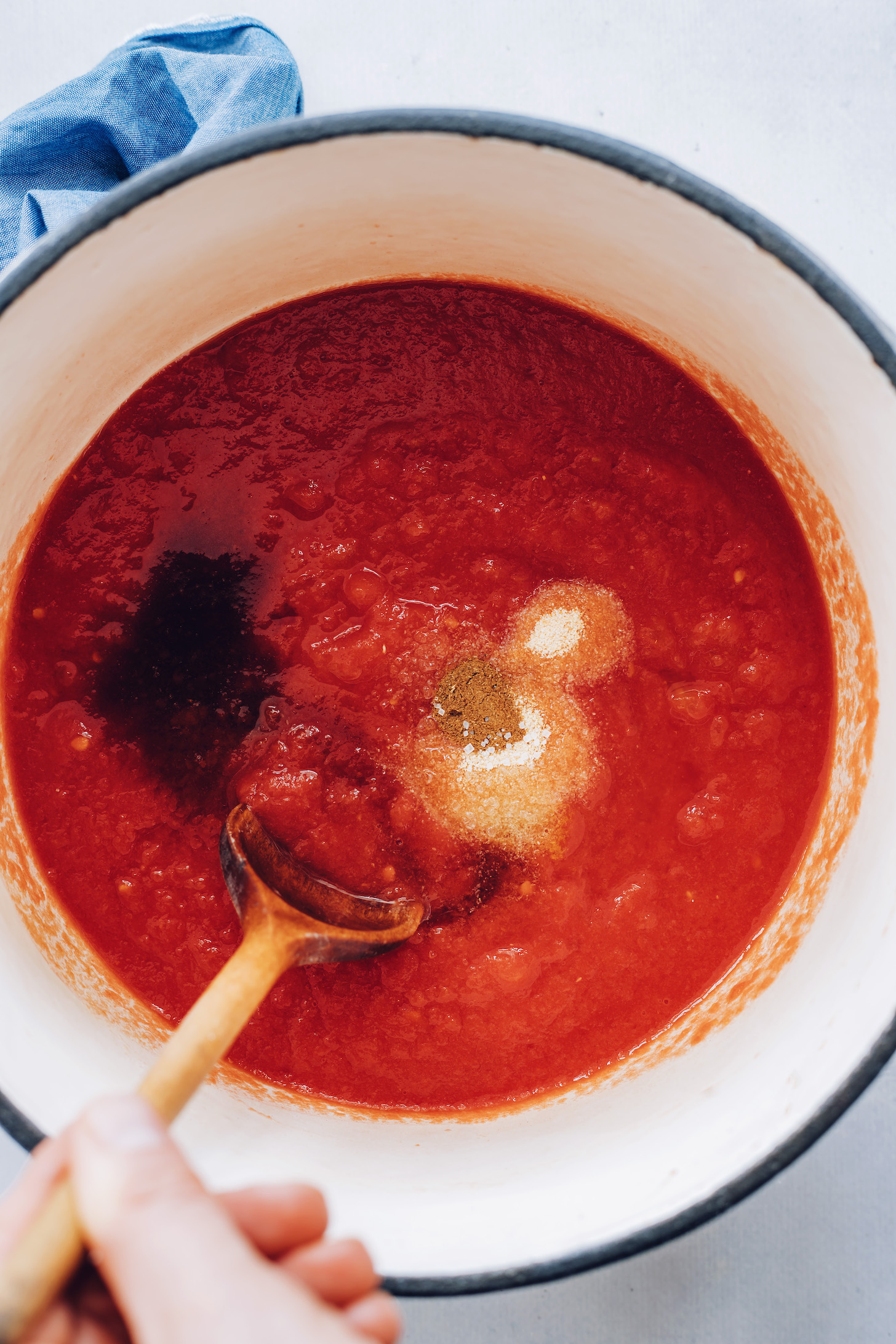 Pot of tomato purée, maple syrup, vinegar, salt, and spices