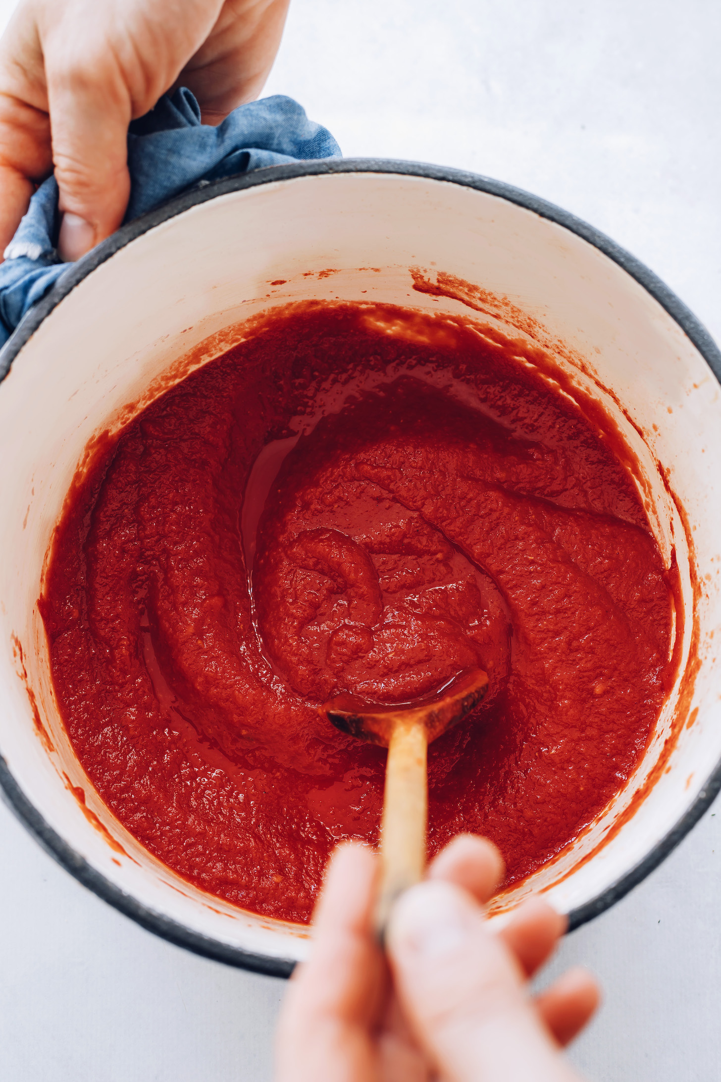 Stirring a pot of easy homemade ketchup