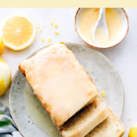 Slices of vegan and gluten-free lemon loaf cake on a plate with lemon icing