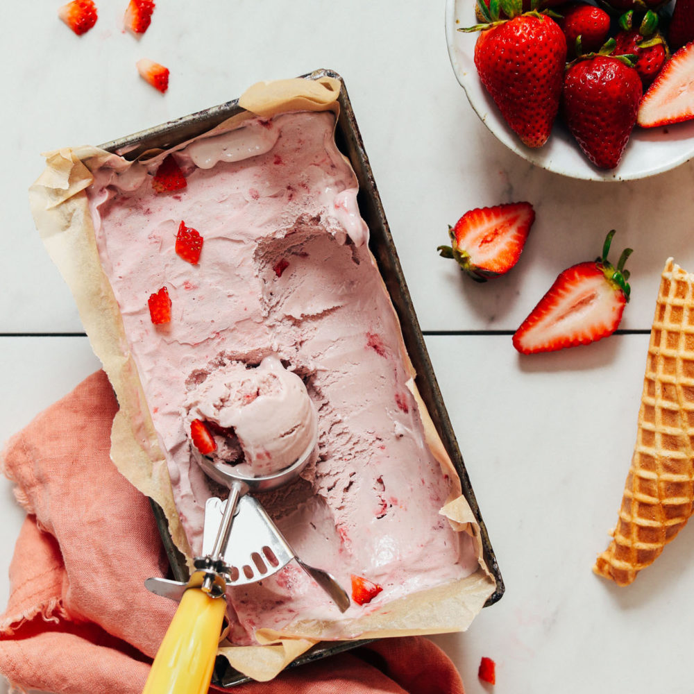 Loaf pan of vegan strawberry ice cream made with fresh strawberries