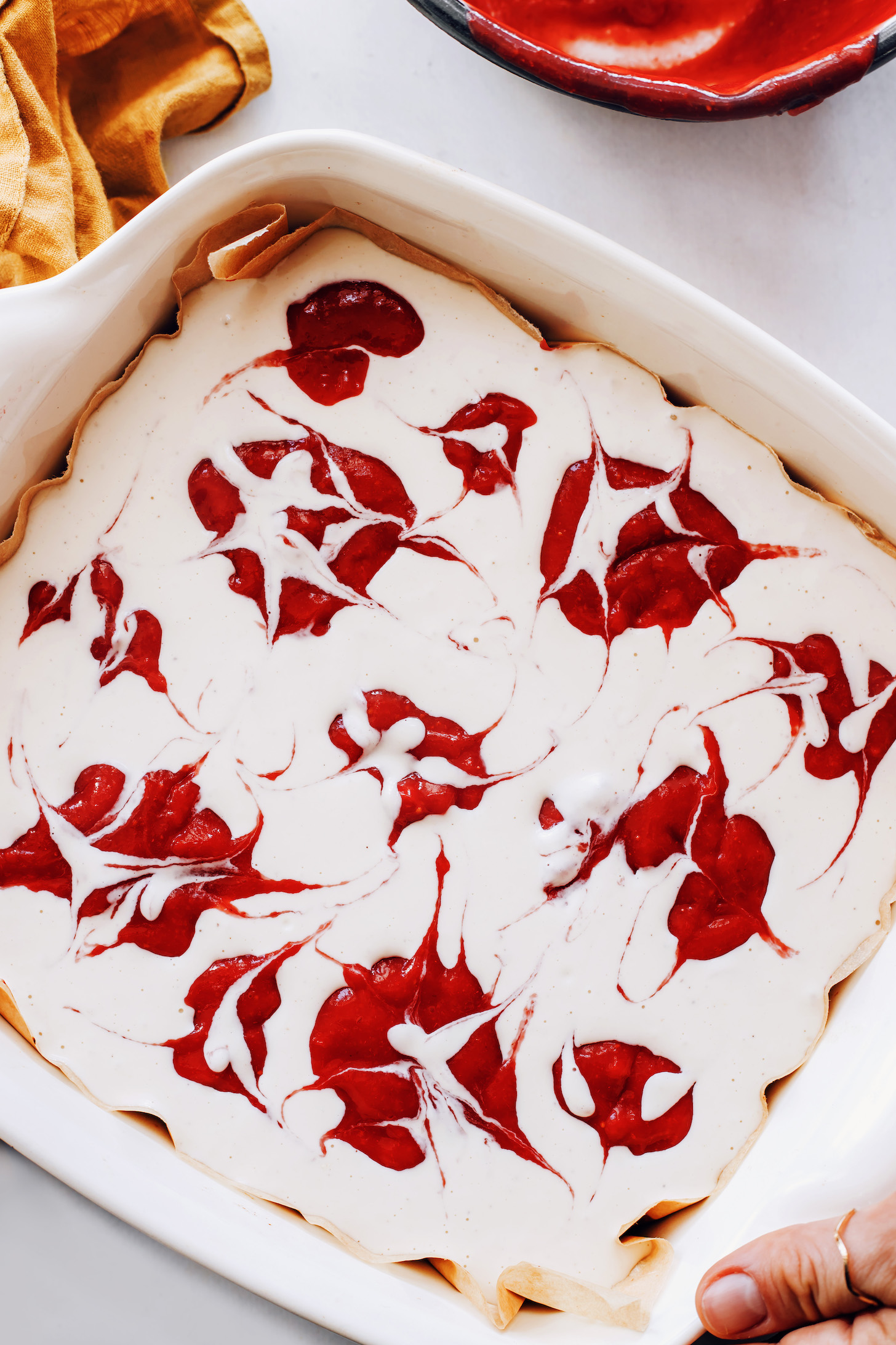 Swirls of strawberry purée in a creamy cashew cheesecake filling