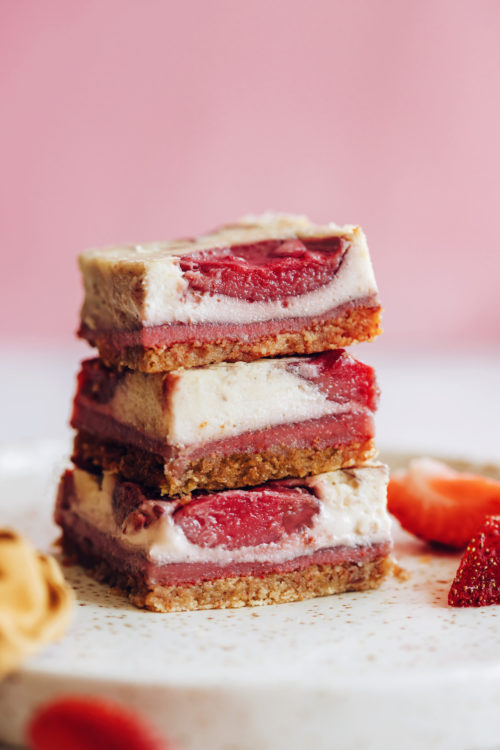 Stack of three gluten-free vegan strawberry cheesecake bars