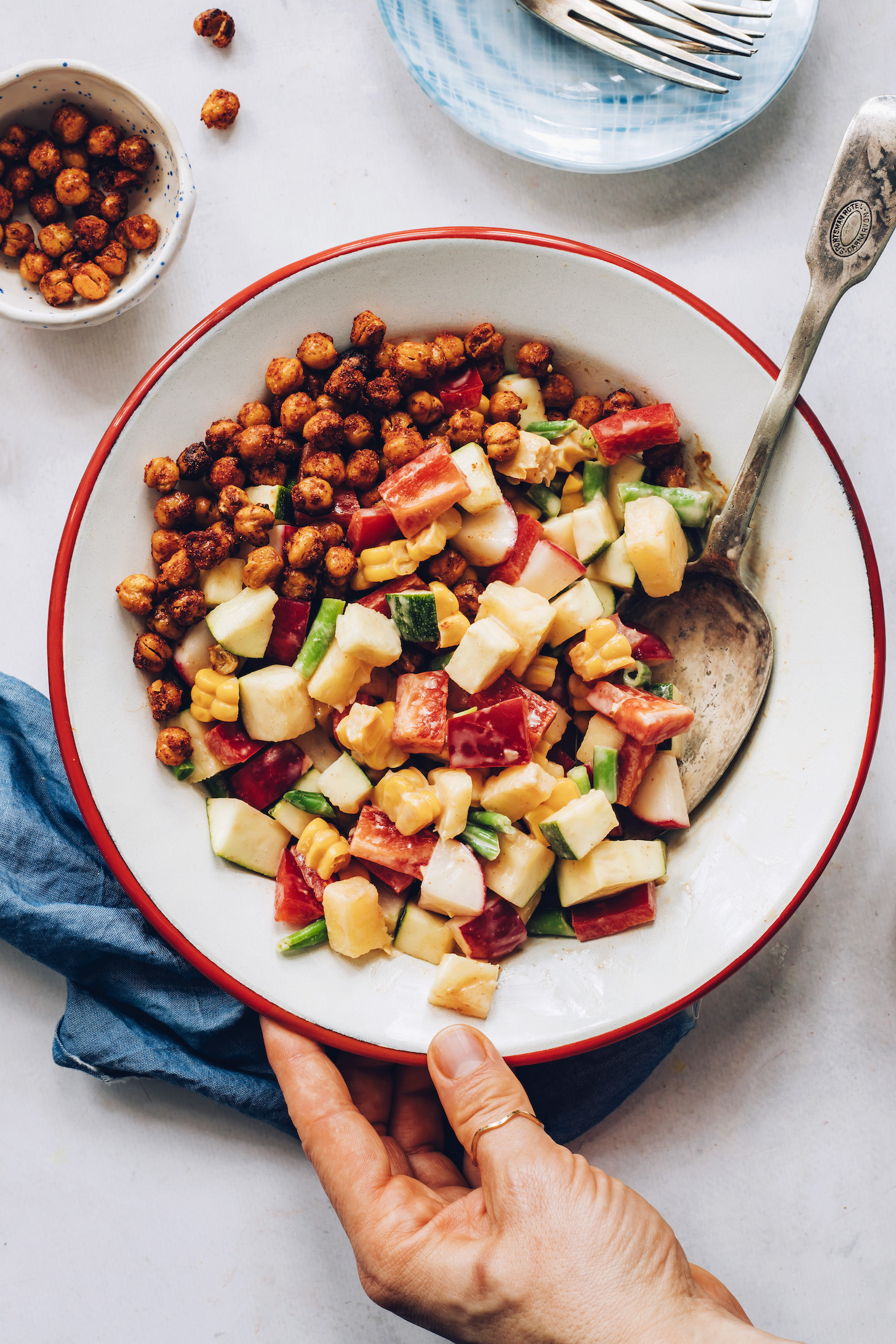 Bowl of our creamy summer salad recipe with BBQ chickpeas on the side