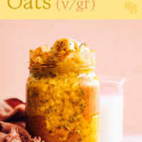 Jar and bowl of golden milk overnight oats with a glass of almond milk