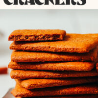 Stack of homemade graham crackers with text above it saying vegan + gluten-free crispy graham crackers