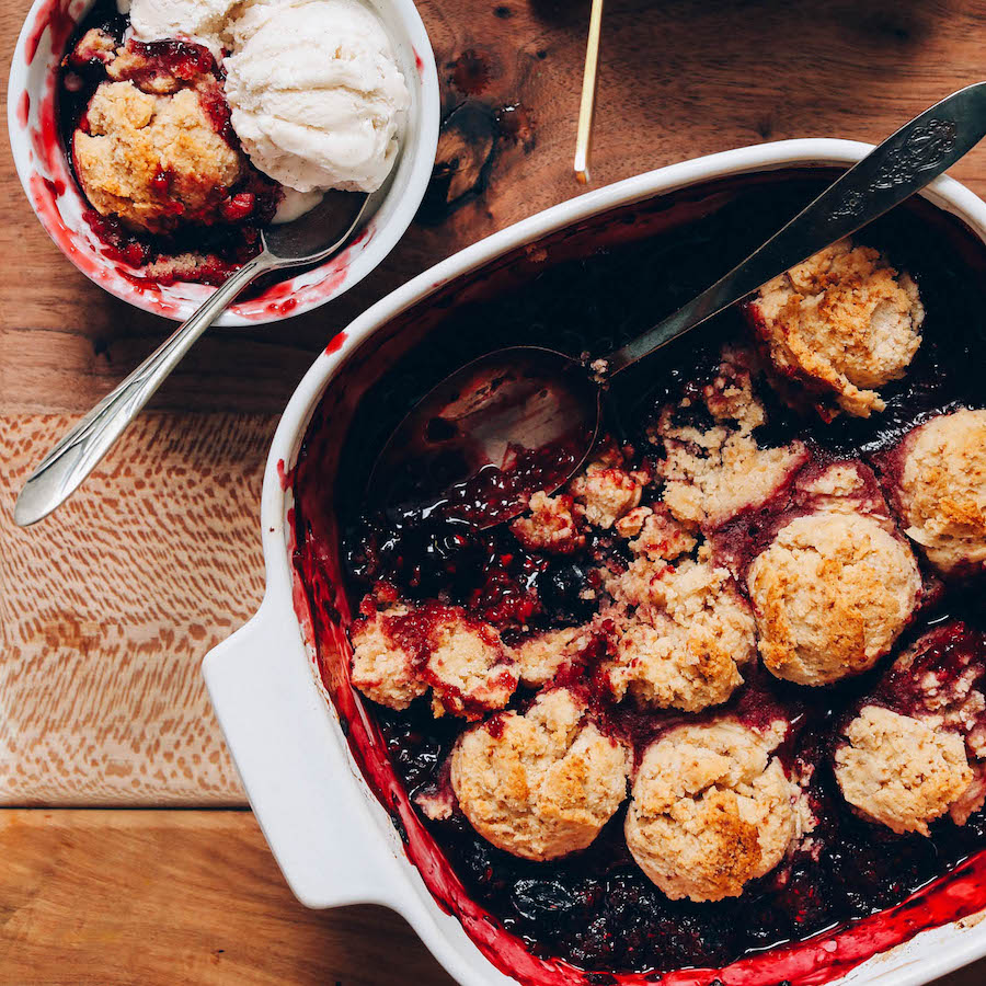 Bowl and pan of gluten free berry cobbler