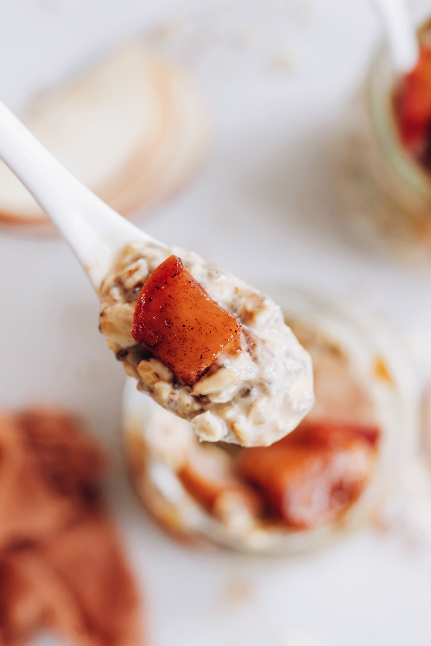Cooked cubed apple in a spoonful of overnight oats