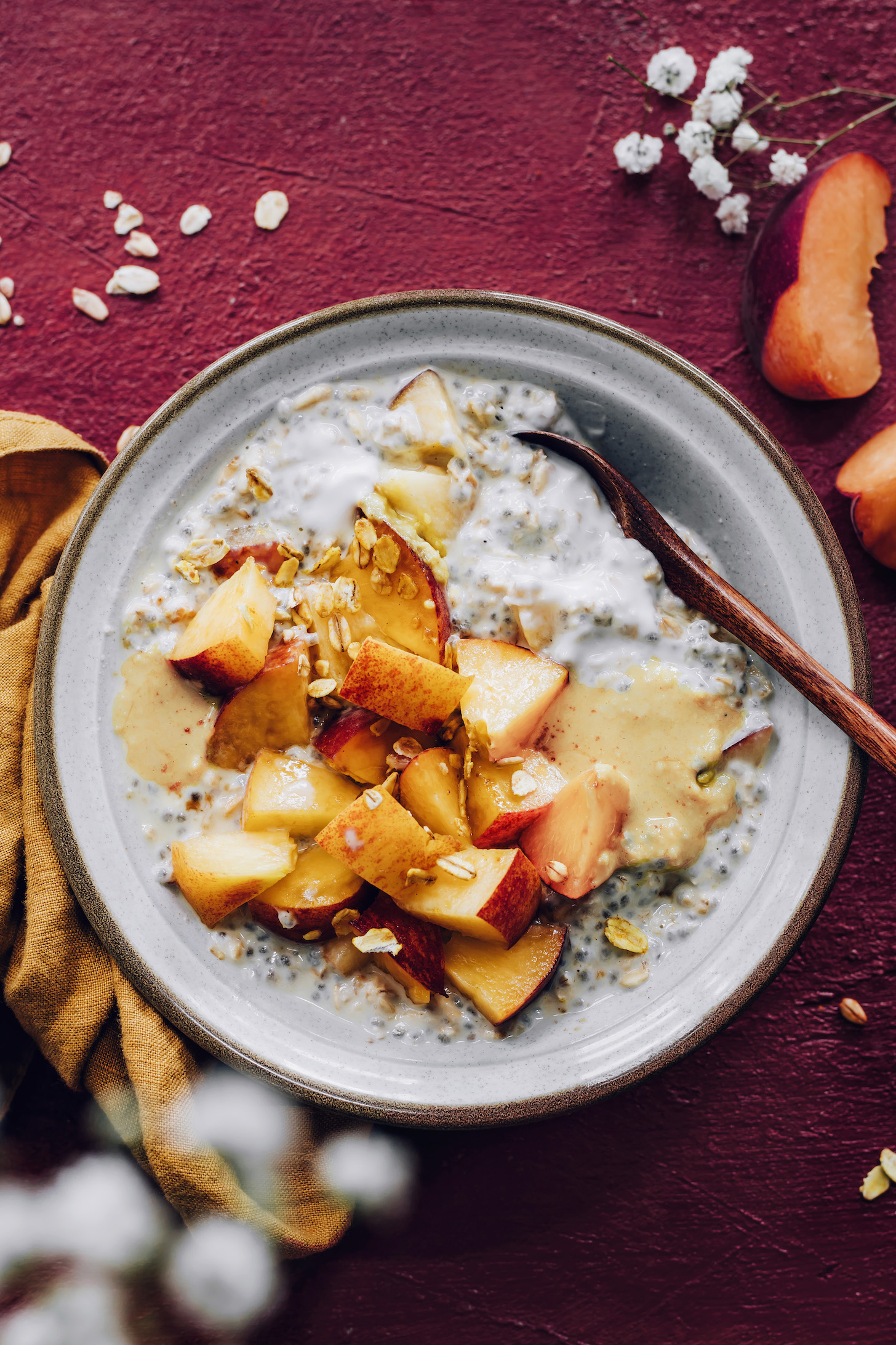 Fresh sliced peaches on top of a bowl of overnight oats