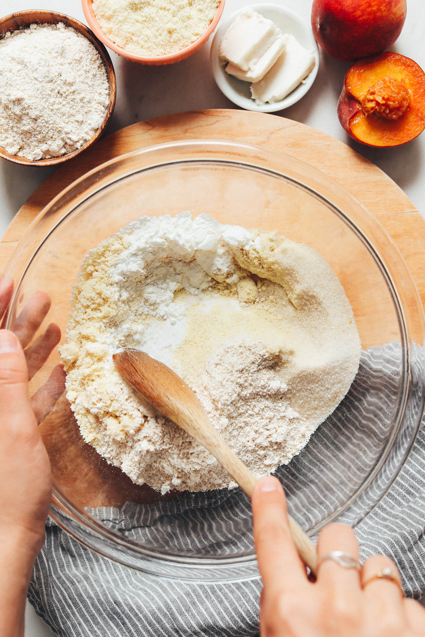 Mixing potato starch, almond flour, oat flour, baking powder, and cane sugar in a bowl