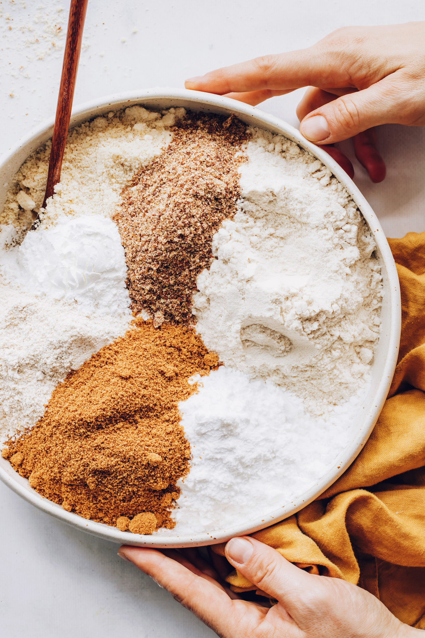 Bowl of gluten-free flours, flax, baking powder, coconut sugar, and salt
