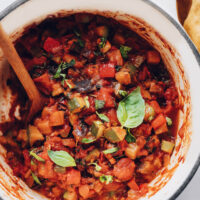 Pot of our easy ratatouille recipe topped with fresh basil