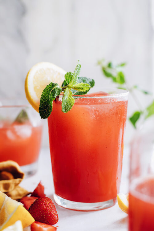 Glasses of homemade strawberry lemonade topped with fresh mint