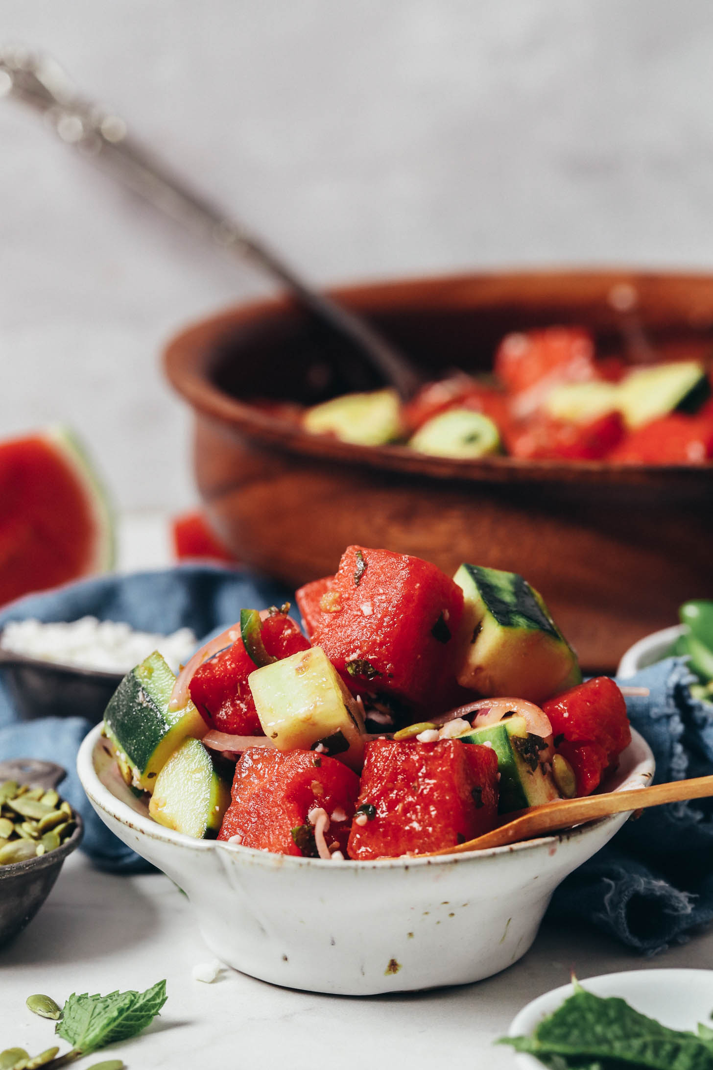 Small overflowing bowl of watermelon cucumber salad