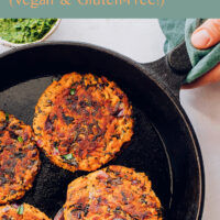 Skillet of vegan and gluten-free kale and sweet potato fritters with mint chutney on the side