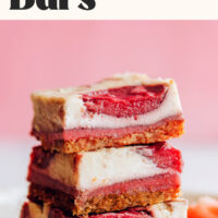 Stack of vegan gluten-free strawberry cheesecake bars