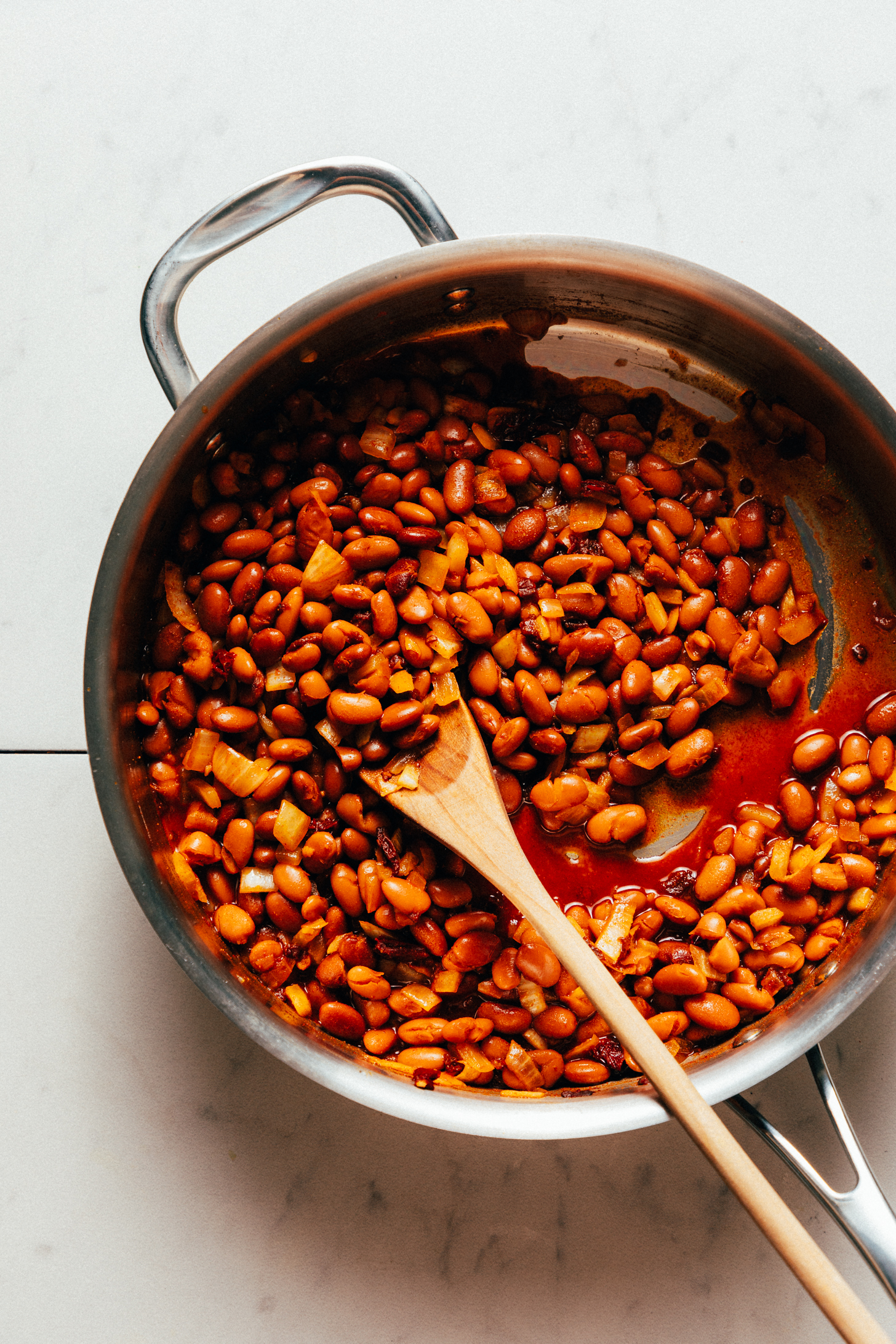 Skillet of pinto beans with sautéed onion and spices