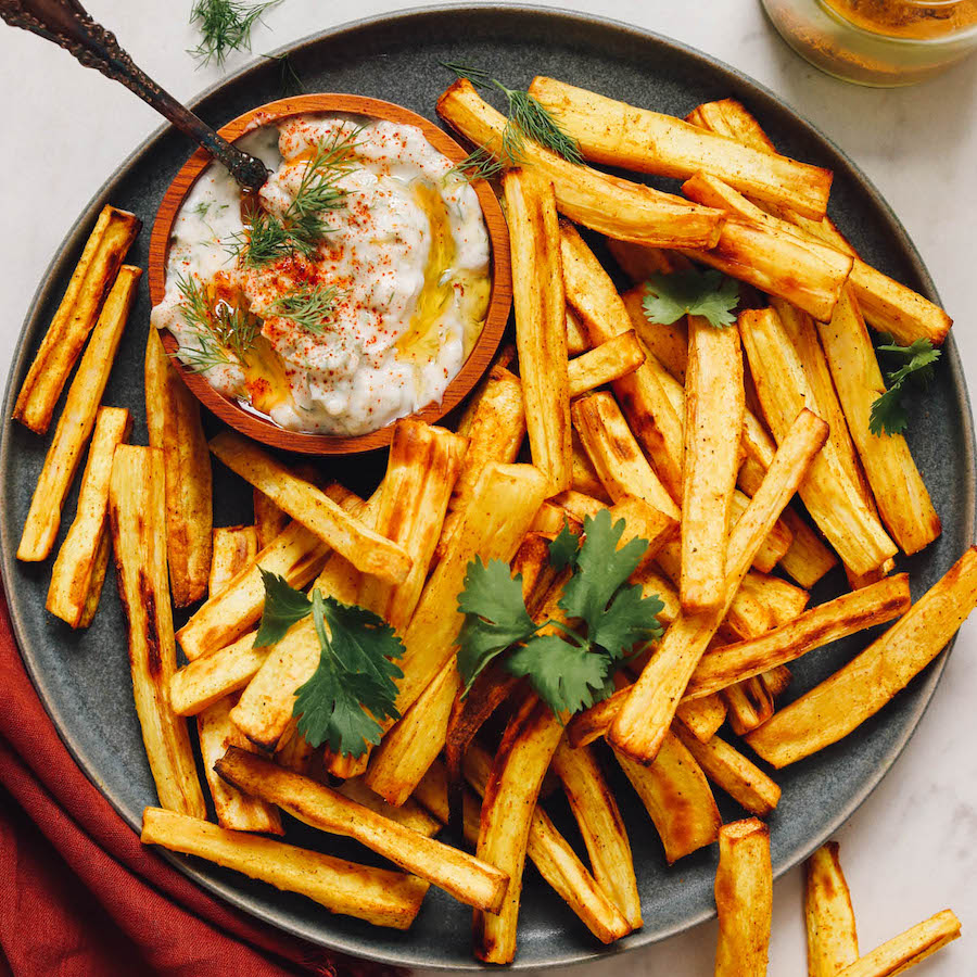 Plate of baked parsnip fries and dairy-free yogurt sauce