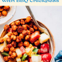 Bowl of creamy vegan summer salad with bbq chickpeas with a fork in it